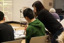 Kiri Lee teaching ASIA 090 students how to do calligraphy