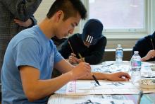 Lehigh Lunar New Year Celebration participants practice Japanese caligraphy
